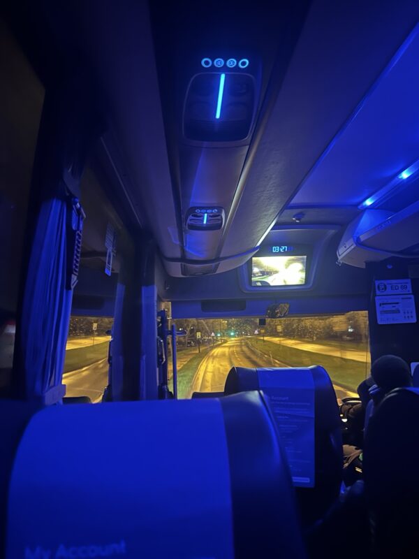 inside a bus with a road and lights