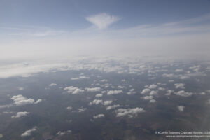 aerial view of clouds and land from an airplane