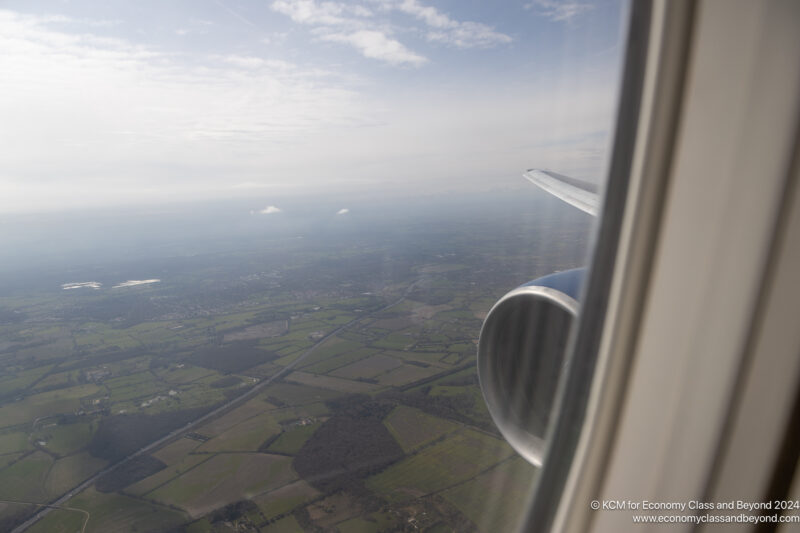 an airplane wing and a view of the landscape