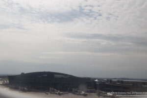 a building with many windows and a lot of planes in the background