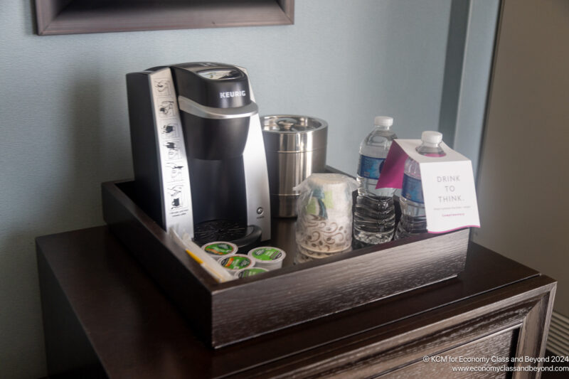a tray with coffee machine and other items on it