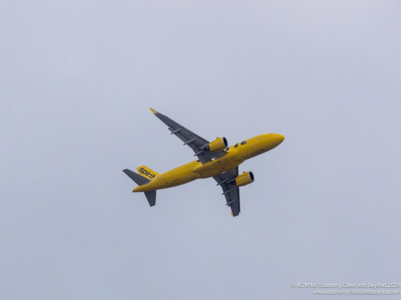 a yellow airplane flying in the sky