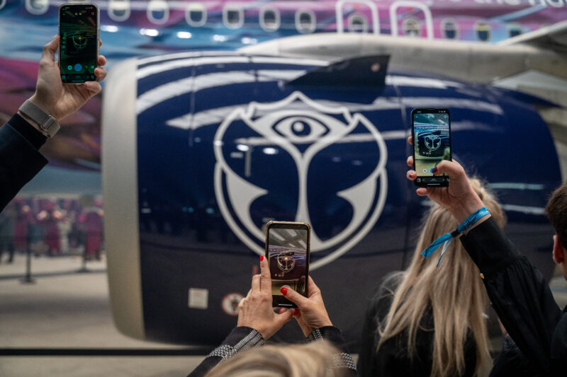 a group of people taking a picture of a plane