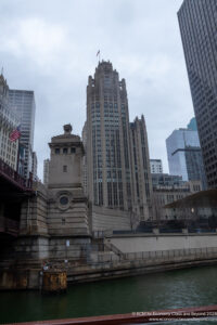 a river with a bridge and a building in the background