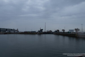 a body of water with a dock and buildings in the background