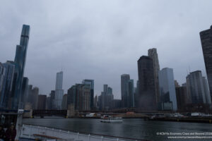 a city skyline with a boat on the water