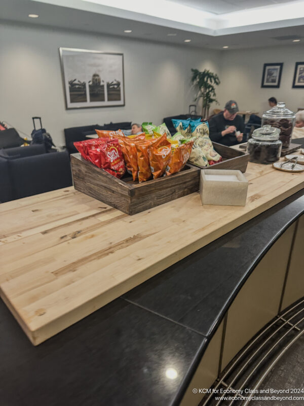 a wooden box with bags of chips on a table
