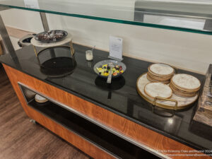 a buffet table with plates of food and desserts