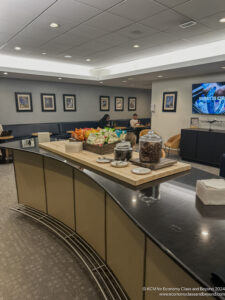 a room with a counter and a couple of people sitting in the background