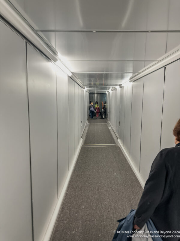 a long hallway with people walking in the distance