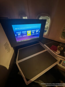 a screen on a table in an airplane