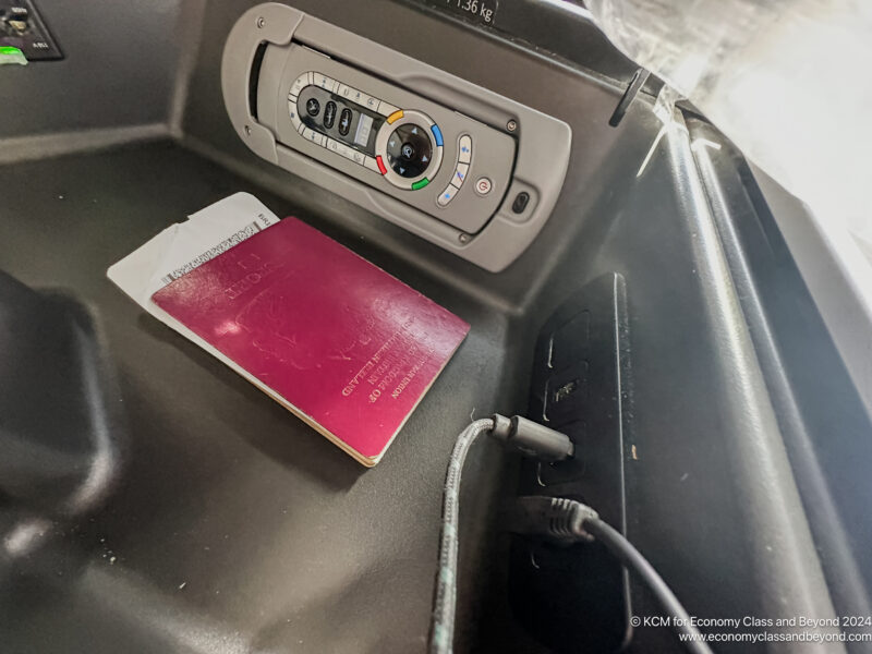 a passport and a power outlet in a car