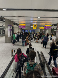 a group of people walking down an escalator