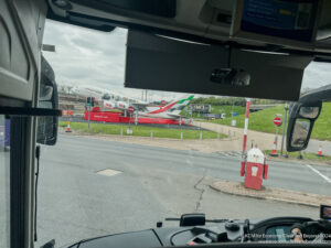 a view from a bus window of a plane on a runway