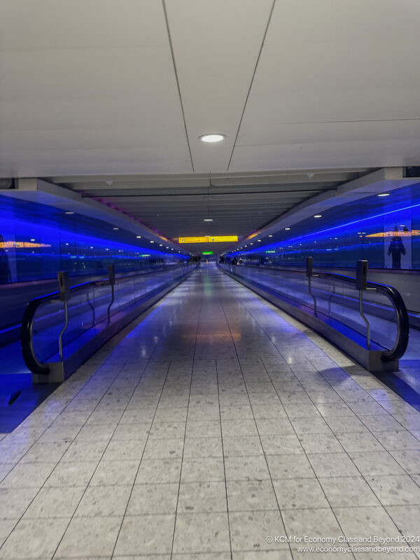 a walkway with blue lights