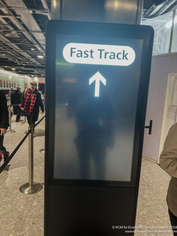 a sign with a person standing in front of it