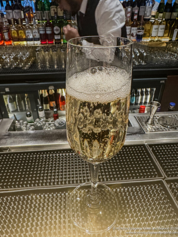 a glass of champagne on a bar