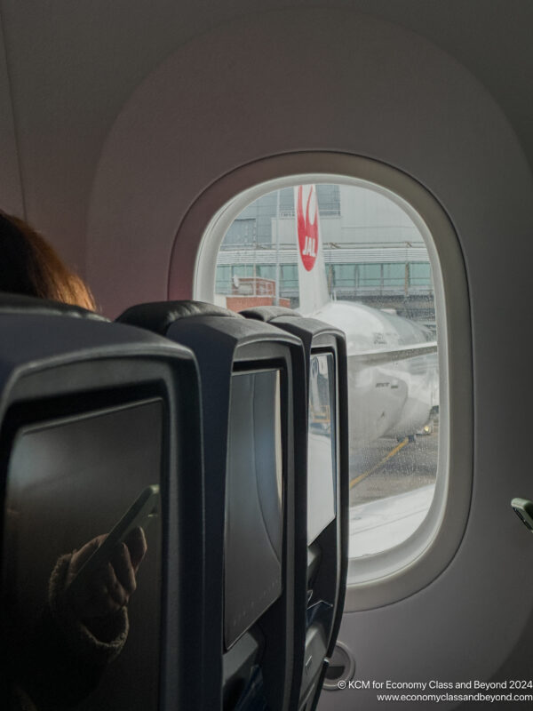 a window with a plane in the background