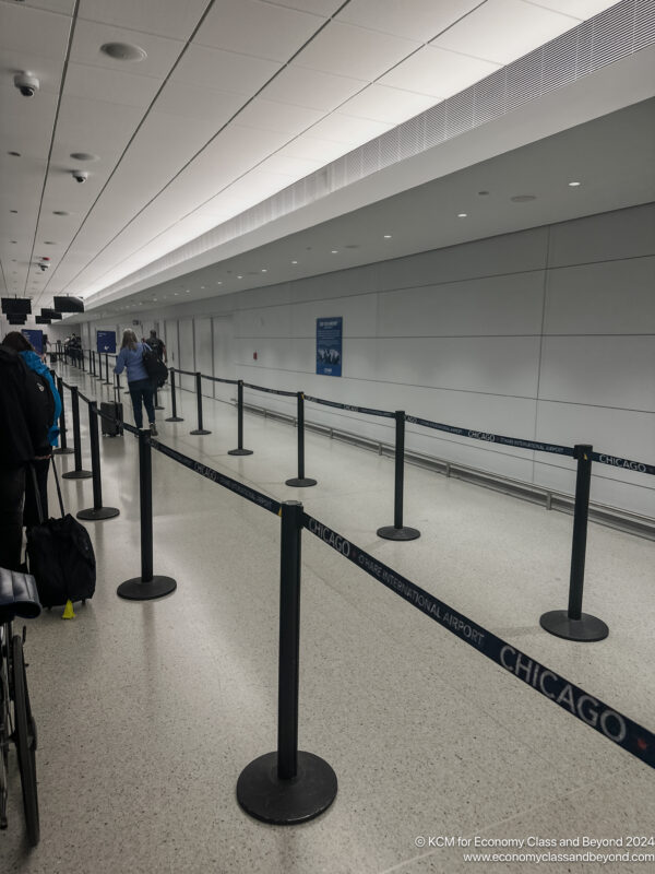 people standing in a line in a airport