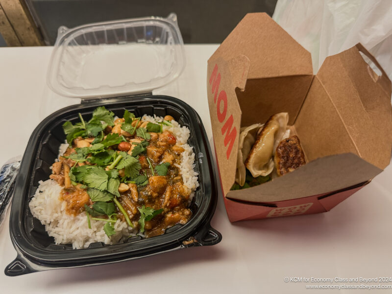 a take out box with food in it