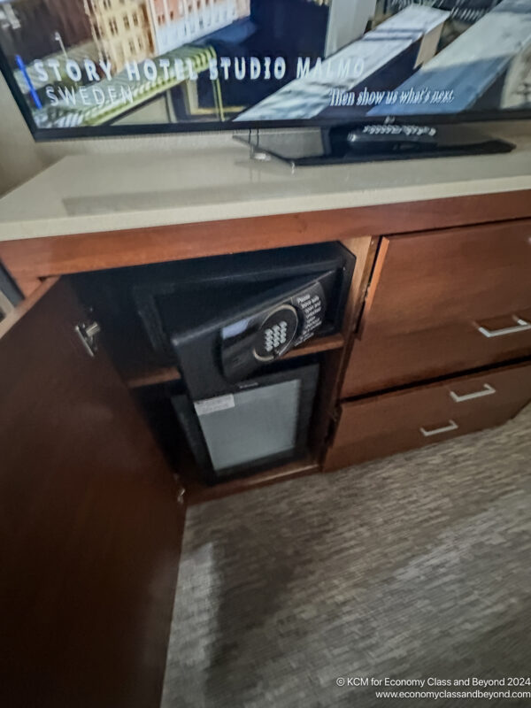 a tv and a safe under a cabinet