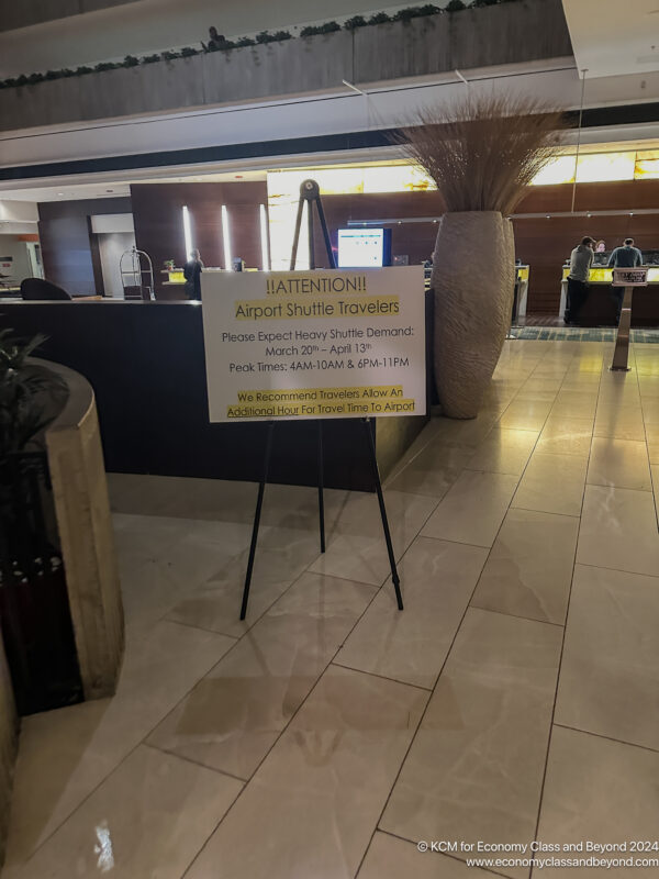 a sign on a stand in a lobby