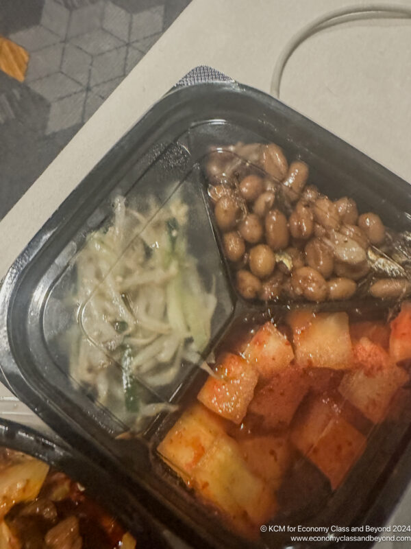 a black tray with food in it