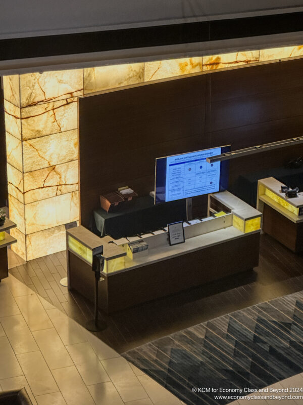 a hotel reception desk with a screen