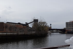 a river with a bridge and buildings