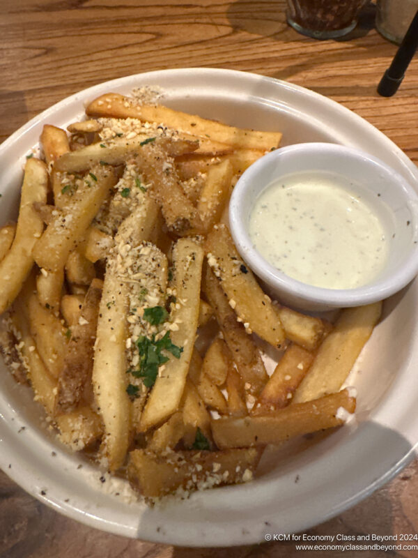 a plate of french fries with sauce