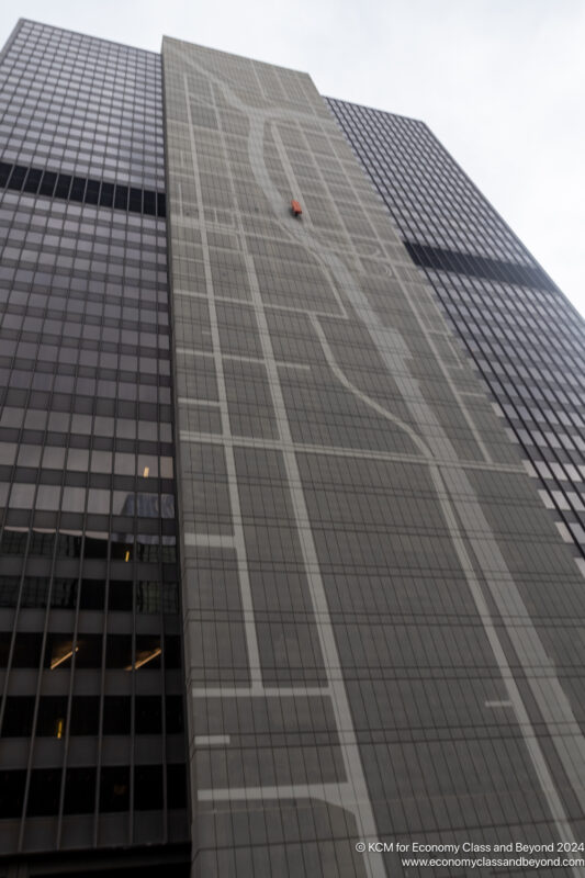 a tall building with a red object on the side