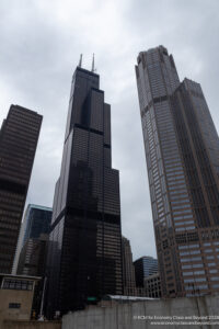 a group of tall buildings with Willis Tower in the background