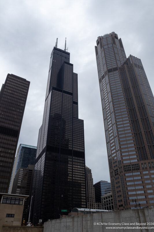 a group of tall buildings with Willis Tower in the background