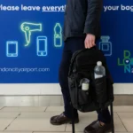 a person holding a bag with a bottle of water