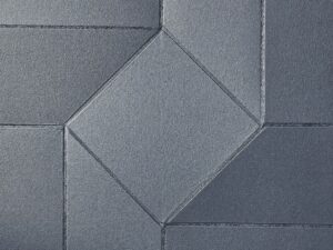 a grey brick wall with a diamond shaped design