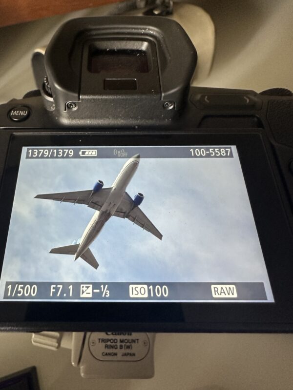a camera with a screen showing an airplane