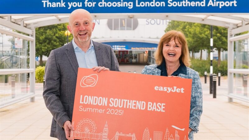 a man and woman holding a sign