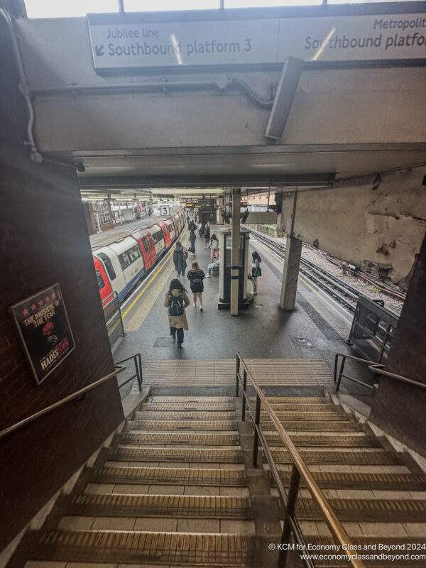 a train station with stairs and people