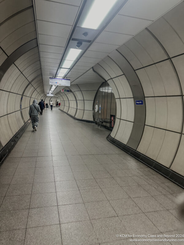 a group of people walking in a tunnel