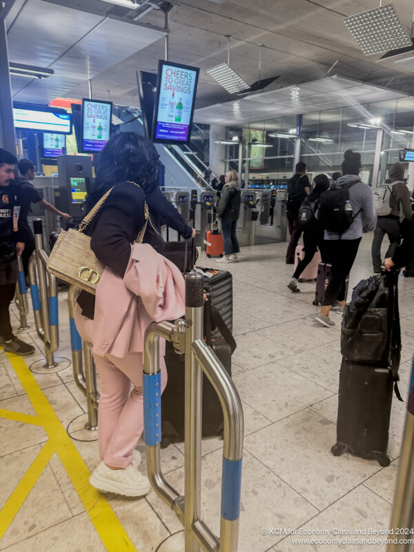 a group of people walking through a gate