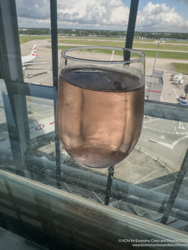 a glass of liquid on a window sill