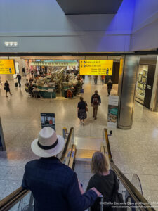 people walking down an escalator in a building