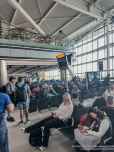 a group of people sitting in chairs in an airport