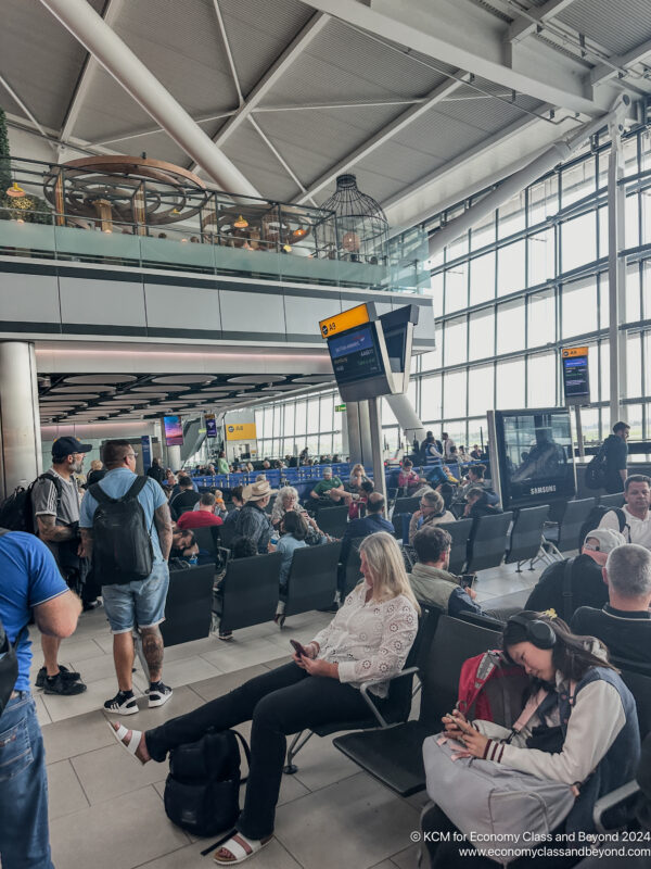 a group of people sitting in chairs in an airport