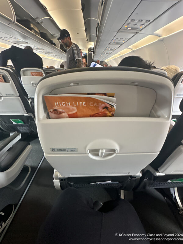 an airplane seat with a magazine in it