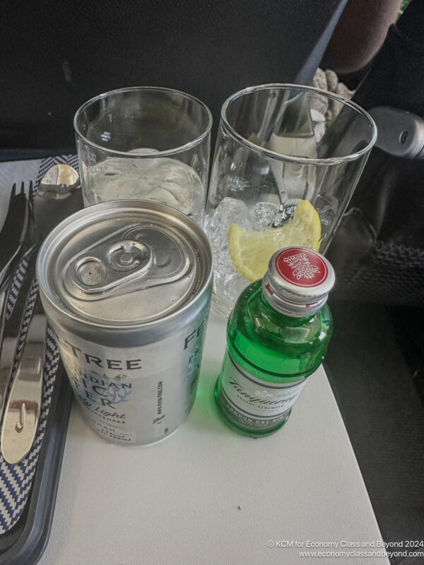 a can and glasses on a tray