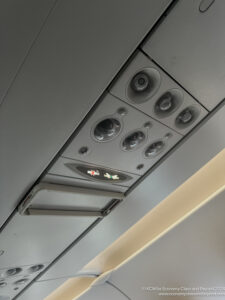 a grey panel with buttons and a light on the ceiling