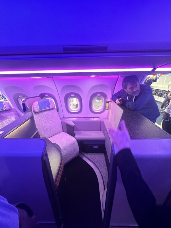 a person pointing at a table in an airplane