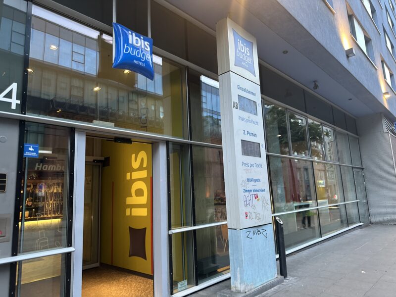 a building with glass windows and a sign