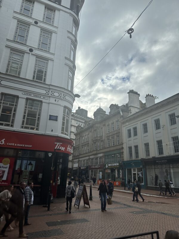 a street with buildings and people walking